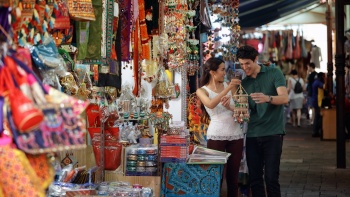 Couple browsing souvenirs along the Little India street stall