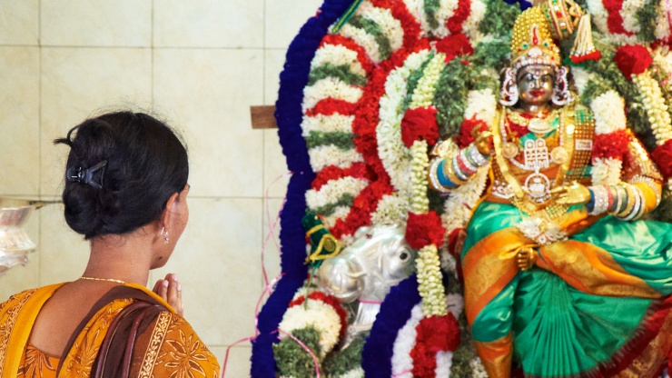 A lady praying at the Sri Veeramakaliamman Temple
