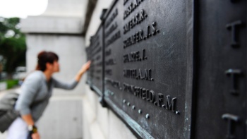 A patron viewing the names etched on the Cenotaph war memorial