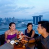 Group shot of three friends dining with a sky view atop LeVeL33