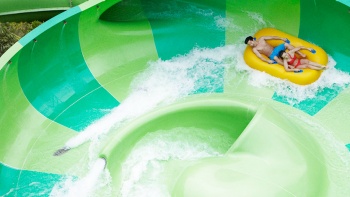 Couple on the Pipeline Plunge water ride at Adventure Cove Waterpark™.