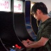 Xian in front of an arcade machine